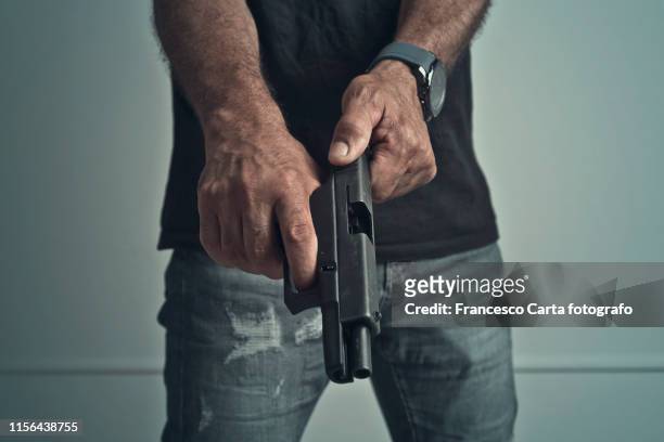man with gun - hand holding gun stock pictures, royalty-free photos & images