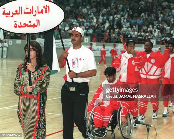 The United Arab Emirates team of disabled athletes marches at the opening session of the first Pan-Arab Games, Special Needs Tournament, which were...