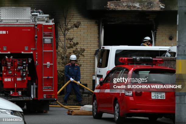 Firefighter works the scene where over 30 people died in a fire at the Kyoto Animation company building in Kyoto on July 19, 2019. - Details emerged...