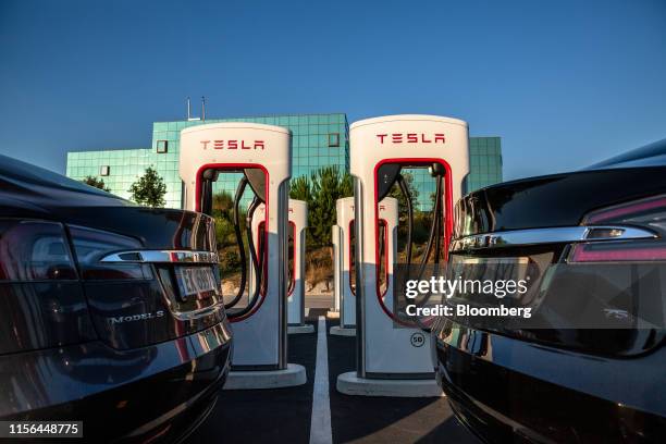 Two Tesla Inc. Model S electric vehicles charge at a Supercharger station in Sant Cugat, Spain, on Wednesday, July 10, 2019. Tesla is poised to...