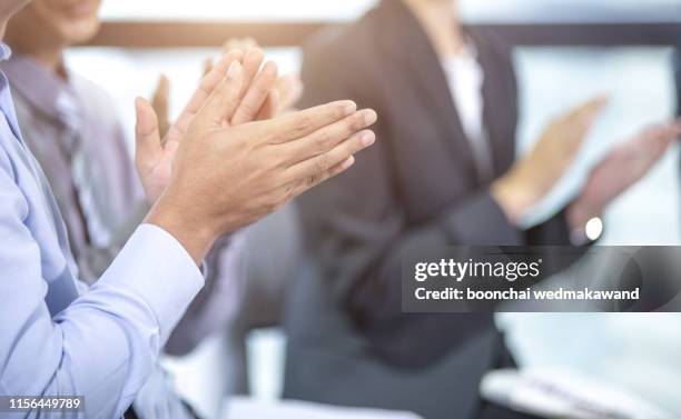 close-up of business people clapping hands. business seminar concept - aplausos fotografías e imágenes de stock