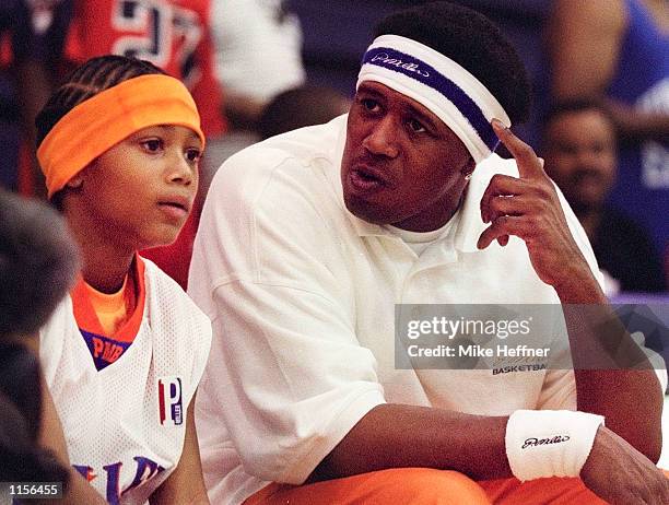 Rapper Lil' Romeo listens to his father, rapper Master P in a basketball game at the 2002 AAU National Boys 12 & Under Basketball Championships July...