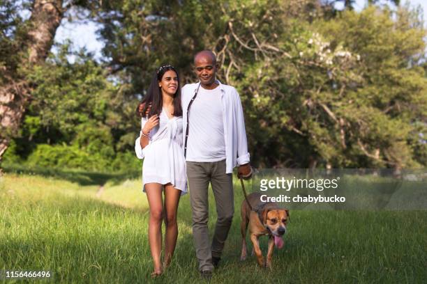 father and daughter walking with dog - african pit bull stock pictures, royalty-free photos & images