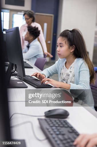 Computer Lab Picture Grlis Young Girl Does Homework In Library Computer Lab High-Res Stock Photo ...