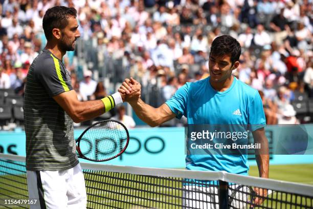 Marin Cilic of Croatia and Christian Garin of Chile shake hands at the net after their First Round Singles Match during Day One of the Fever-Tree...