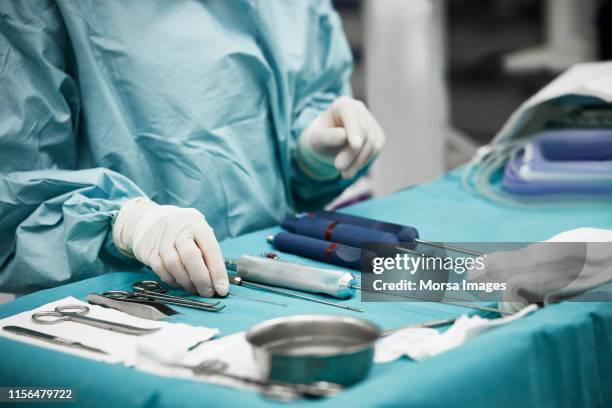 female doctor arranging surgical equipment - reconstruction stock-fotos und bilder