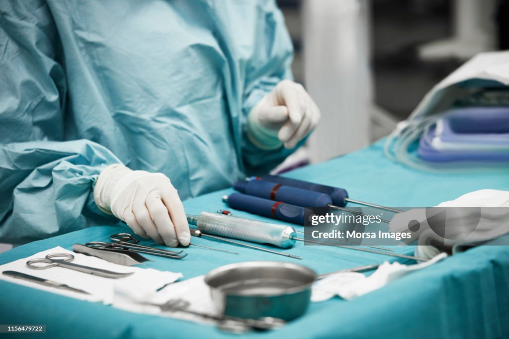 Female doctor arranging surgical equipment