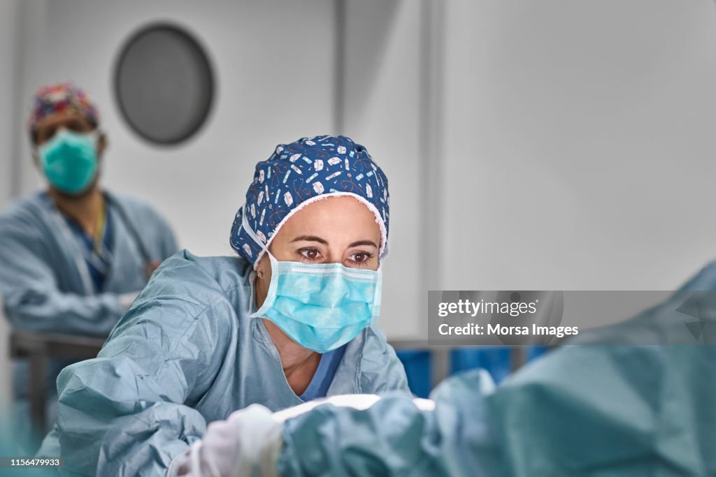 Healthcare workers performing plastic surgery