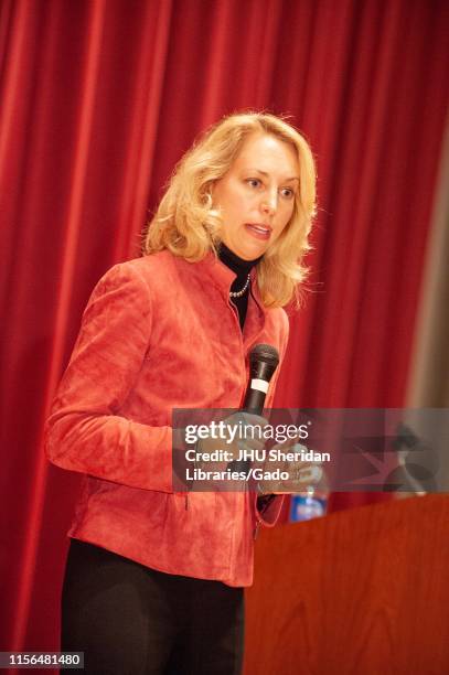 Writer and former Central Intelligence Agent Valerie Plame, holding a microphone while speaking at a Milton S Eisenhower Symposium at the Johns...