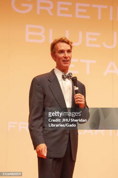 Three-quarter length shot of science communicator Bill Nye, holding a microphone while speaking during a Milton S Eisenhower Symposium at the Johns...