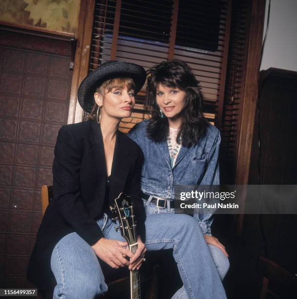 Portrait of American sibling Country musicians Janis Gill and Kristine Arnold, together the duo Sweethearts of the Rodeo, as they pose backstage at...