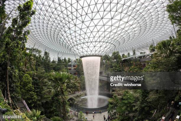 the world's tallest indoor waterfall at jewel changi airport - changi stock pictures, royalty-free photos & images