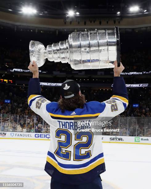 Chris Thorburn of the St. Louis Blues holds the Stanley Cup following the Blues victory over the Boston Bruins at TD Garden on June 12, 2019 in...