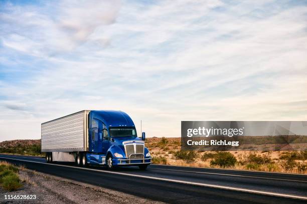 long haul semi truck on a rural western usa interstate highway - trucking stock pictures, royalty-free photos & images