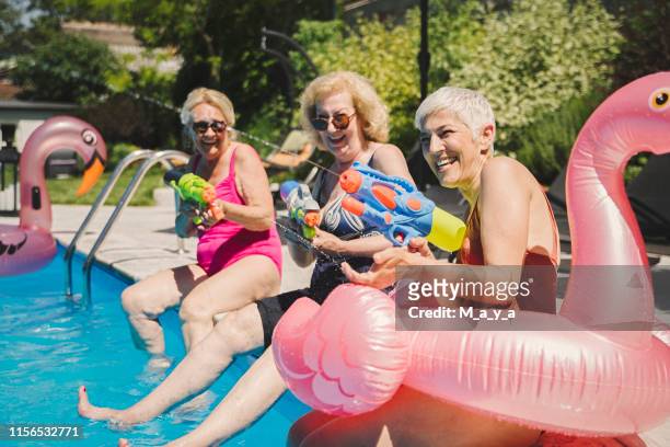 seniors having summer fun - water pistol stock pictures, royalty-free photos & images