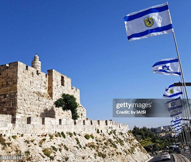 the flags of jerusalem and israel facing the tower of david - jerusalem skyline stock pictures, royalty-free photos & images