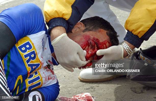 Brazilian cyclist, Diogo Bonini Marquez recieves medical attention after his accident during the final round in cycling of the VII South American...