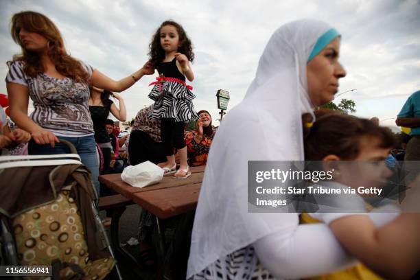 Ramia Dakouche left held the hand of her 3-year-old daughter Fatme Dakouche on Warren Avenue June 17, 2011 as her family attended the 17 annual Arab...