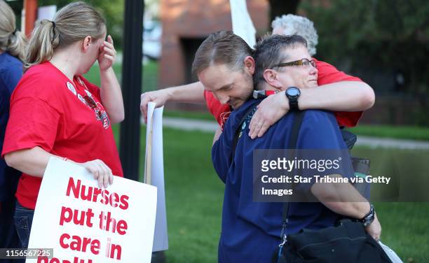 Nurse Donna VanStralen right, was hugged by a co-worker as she walked out of the Abbot Northwestern Hospital at the end of her shift at 7am, to join...