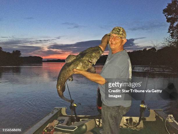 Brian Klawitter hoists a dandy flathead catfish caught one evening last week on the Mississppi River between Red Wing, Minn., and Hager City, Wis....