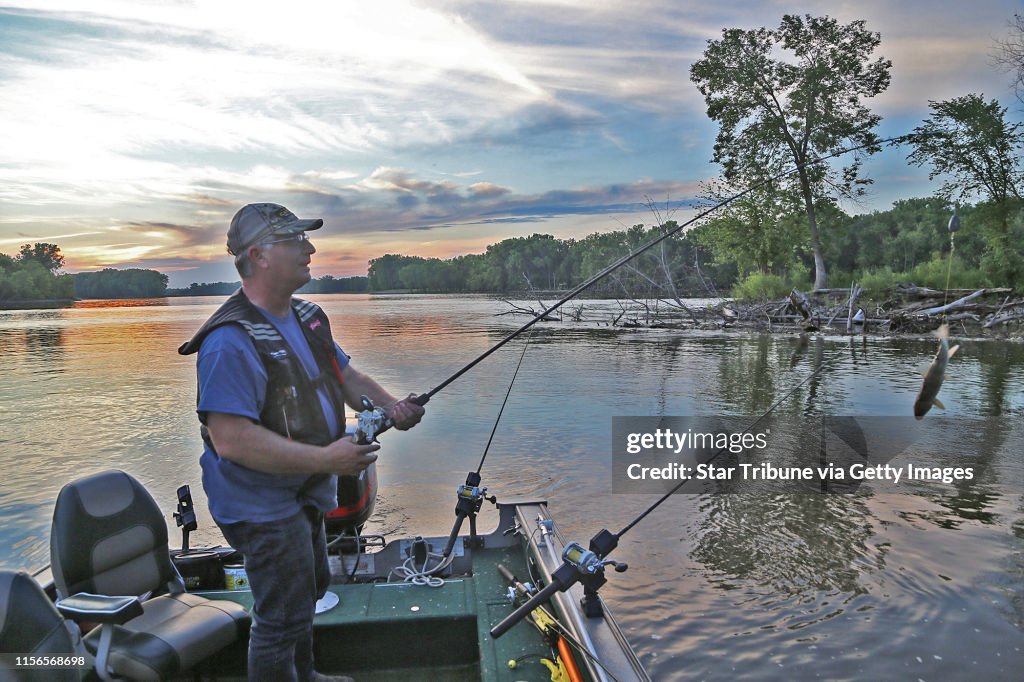 Brian Klawitter prepares to cast a line baited with a sucker one evening last week on the Mississppi River between Red Wing, Minn., and Hager City, Wis. Suckers are largely used to attract flathead catfish, not channel catfish.