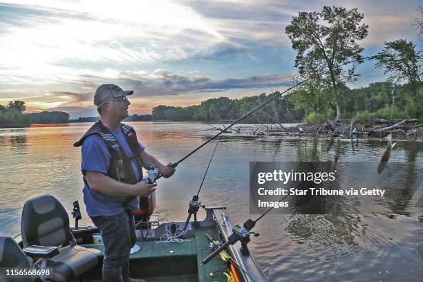 Brian Klawitter prepares to cast a line baited with a sucker one evening last week on the Mississppi River between Red Wing, Minn., and Hager City,...