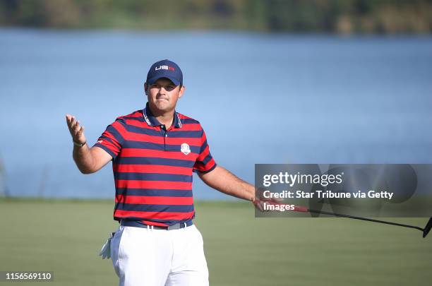 Patrick Reed gets the crowd involved after sinking a putt on the seventh hole during the morning foursome play. ] JERRY HOLT jerry....