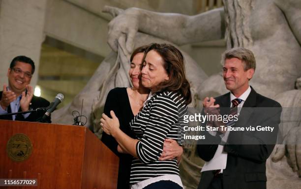 Cathy ten Broeke left and her partner Margaret Miles hugged each other after Minneapolis Mayor R.T. Rybak introduced them along with Jeff Isaacson...