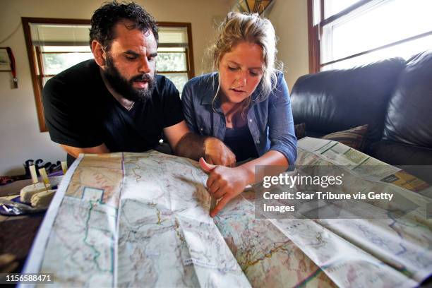 Jeff Alley, left, and Ashley Melco discuss the details of their climb..., News Photo