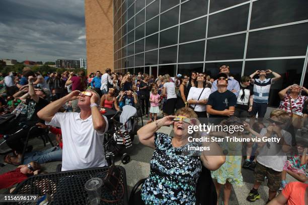 Roger Hahn left and his wife Cheryl Hahn of Buffalo, Minnesota watched a partial eclipse at the Science Museum of Minnesota Monday August 21, 2017 in...