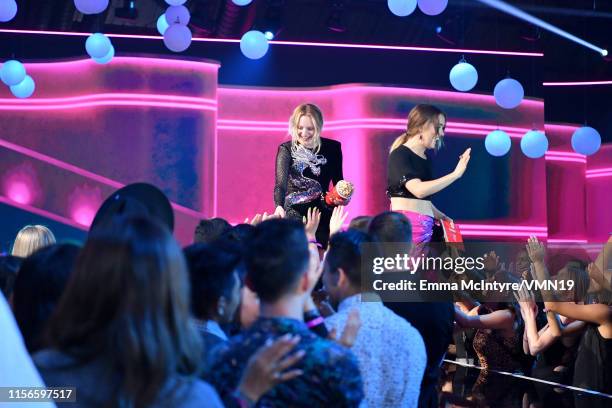 Elisabeth Moss and Haley Lu Richardson speak onstage during the 2019 MTV Movie and TV Awards at Barker Hangar on June 15, 2019 in Santa Monica,...