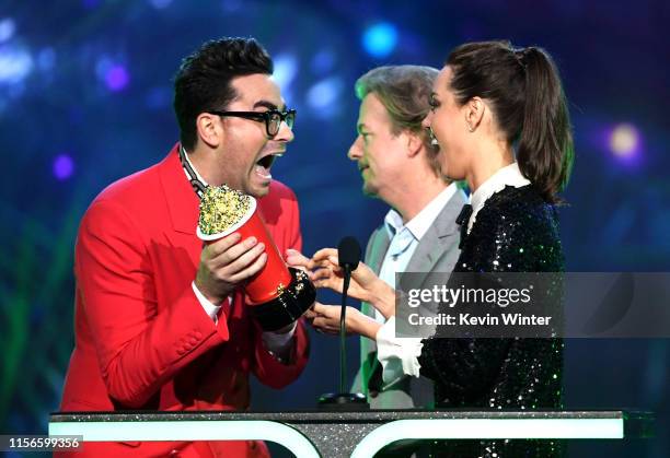 Daniel Levy accepts the Best Comedic Performance award for 'Schitt's Creek' onstage from David Spade and Aubrey Plaza during the 2019 MTV Movie and...