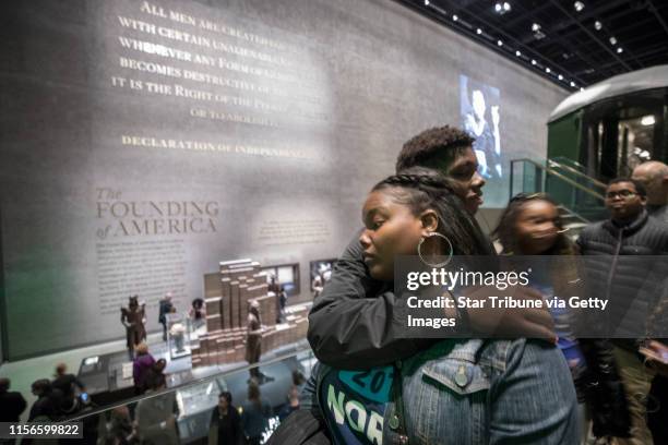 Amil Clark 15, hugged his mom Lakisha Clark-Burgess while the waited in line to see the Emmett Till exhibit at the National Museum of African...