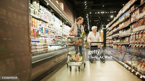 see anything you like? - young woman trolley stock pictures, royalty-free photos & images