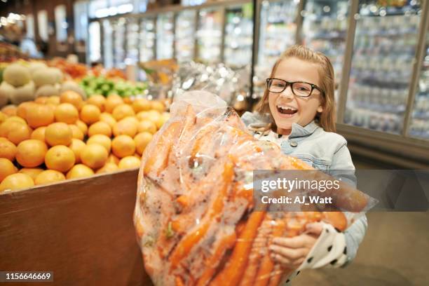 mom says healthy eyesight needs lots of carrots - mini grocery store stock pictures, royalty-free photos & images