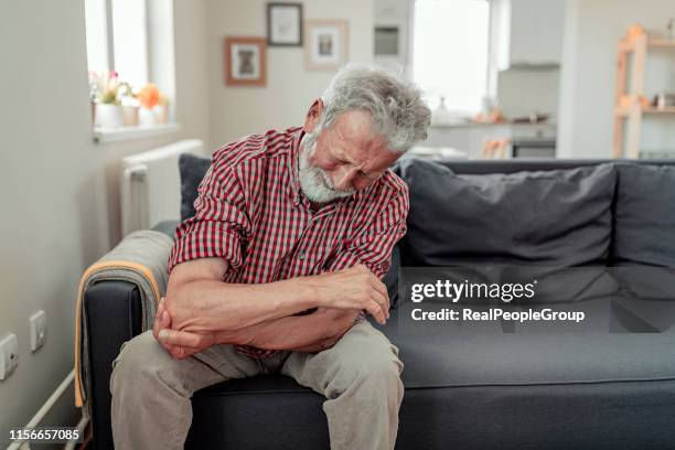 man feeling elbow pain, sport injury, chronic rheumatism, health problem - chronic wound stock pictures, royalty-free photos & images