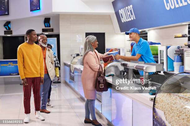 cashier at concession stand in movie theater - amateur theater fotografías e imágenes de stock