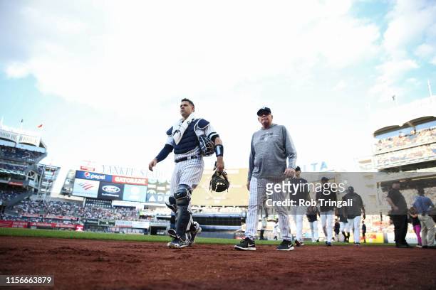 New York Yankees Gary Sanchez and pitching coach Larry Rotschild coming off field before game vs Toronto Blue Jays at Yankee Stadium. Bronx, NY...