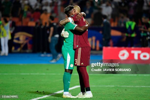 Algeria's goalkeeper Rais M'Bolhi is greeted by Senegal's forward Keita Balde following the 2019 Africa Cup of Nations Final football match between...