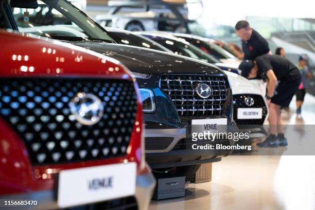 Hyundai Motor Co. Venue compact sport utility vehicle , center, stands on display at the company's Motorstudio showroom in Goyang, South Korea, on...