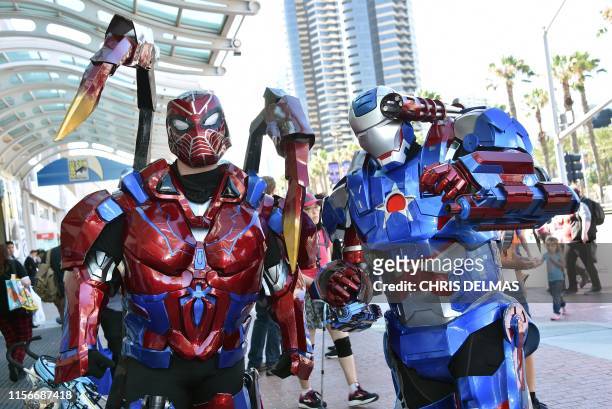Cosplayers dressed as Transformers walk around San Diego, California, during Comic Con on July 19, 2019.