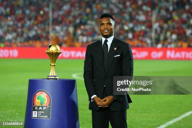 Cameroonian former footballer Samuel Eto'o holds the Africa Cup of Nations trophy prior to the start of the Africa Cup of Nations final soccer match...