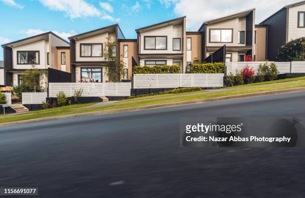 road next to houses. - auckland stock pictures, royalty-free photos & images