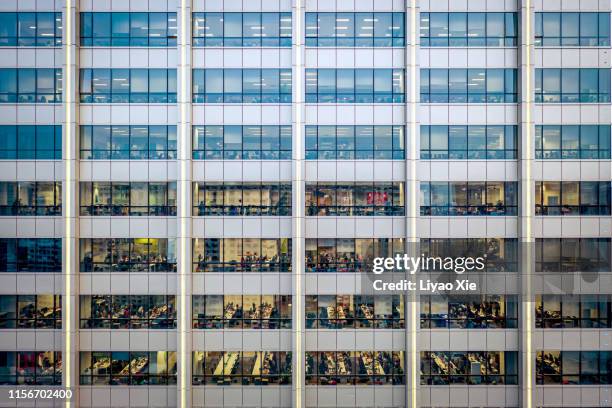 office building at night - bustling office stock pictures, royalty-free photos & images