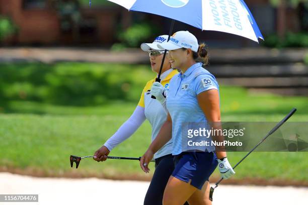 Mirim Lee and Amy Yang, both of Republic of Korea, walk to the 2nd green during round three of the Dow Great Lakes Bay Invitational at Midland...