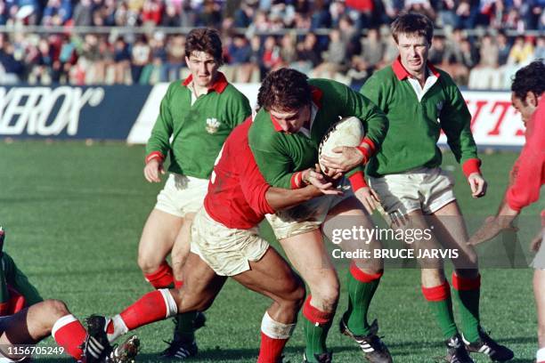 Picture taken on may 29, 1987 at Palmerston North showing Welsh forward Phil Daviesshrugging off a Tonga player's tackle during the match Wales vs....