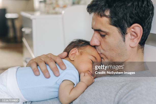 father enjoying at home with his newborn baby boy - father newborn stock pictures, royalty-free photos & images