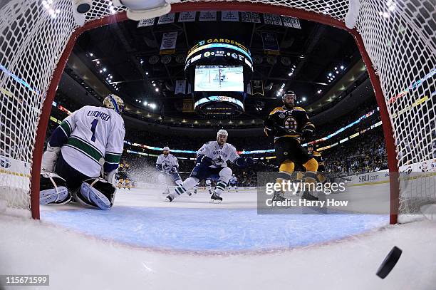 Rich Peverley of the Boston Bruins scores a goal in the first period against Roberto Luongo of the Vancouver Canucks during Game Four of the 2011 NHL...