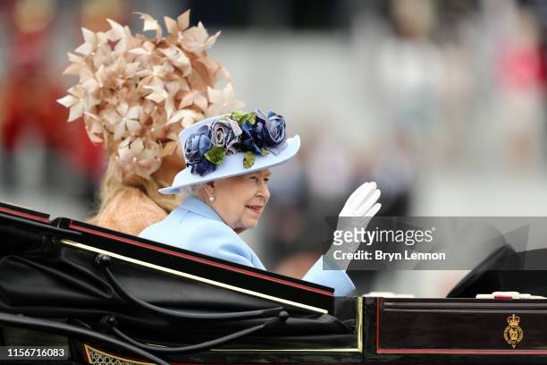 Queen Elizabeth II waves to the crowds as she arrives on day one of Royal Ascot at Ascot Racecourse on June 18, 2019 in Ascot, England.