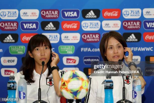Asako Takakura, head coach of Japan and Emi Nakajima of Japan listen to translators during a press conference at Stade de Nice on June 18, 2019 in...